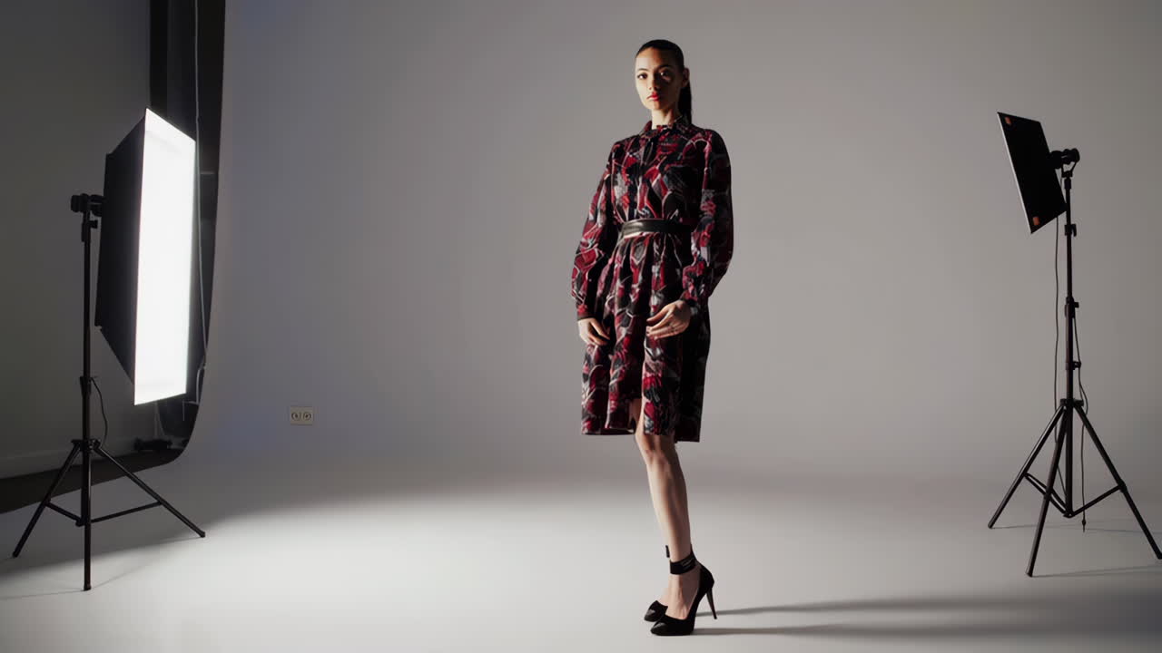 Woman in floral dress taking selfie in studio