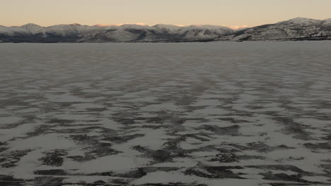winter season along destruction bay at sunset in kluane national park, yukon canada. aerial drone shot