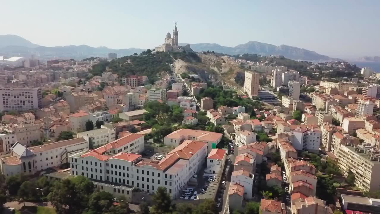 The picturesque and beautiful city of Marseille, France, with the famous  Basilique Notre-Dame de la Garde in the background. Wide angle aerial