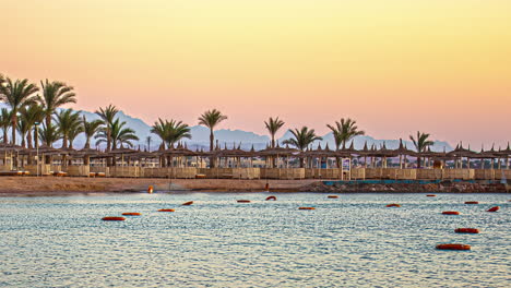 Timelapse-of-a-beach-in-Hurgada,-Egypt-with-patios-and-palm-trees,-no-people