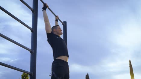 man doing abdominal workout at the pull up bar