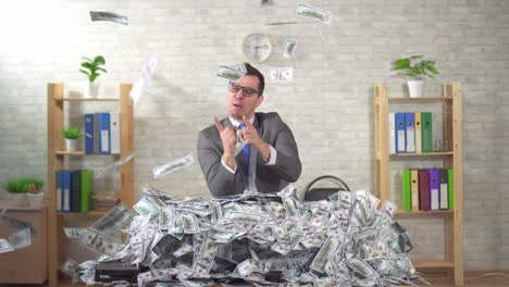 happy man successful businessman rejoices in a pile of banknotes slow mo