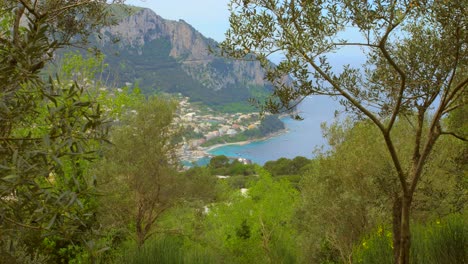 Overlooking-coastline-and-sea-from-Marina-Grande-with-colorful-houses,-blue-water-and-mountains-in-the-background-in-Capri,-Italy