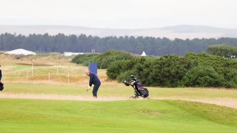 golfer swings on lush green course