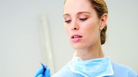 female nurse holding a dental tool