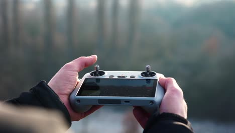 person hold drone remote control and test aircraft wireless maneuver connection