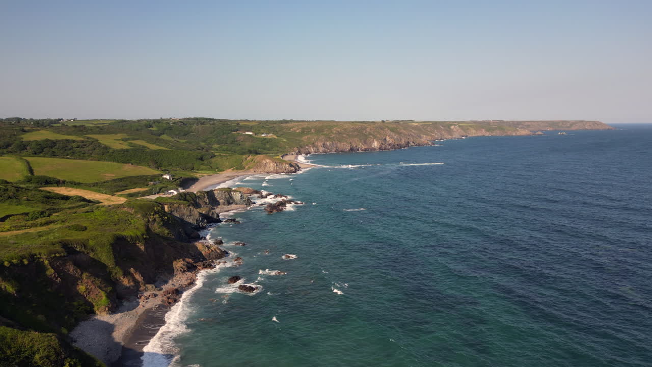 A drone view of the rugged coastline on the south coast of Cornwall, England near the village of Kuggar and Kennack Sands popular with holidaymakers.