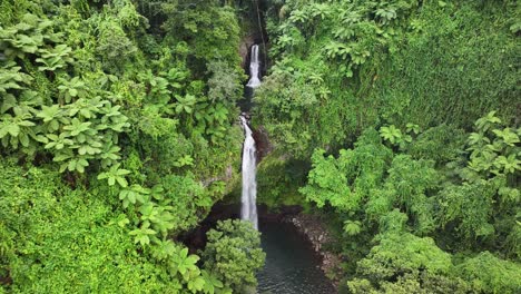 beautiful bouma waterfalls in taveuni island jungle. fiji tourist attraction, drone pull back.