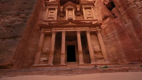 The-Treasury-at-Petra,-historic-UNESCO-heritage-site-carved-into-sandstone-in-Jordan-front-view-and-upward-pan