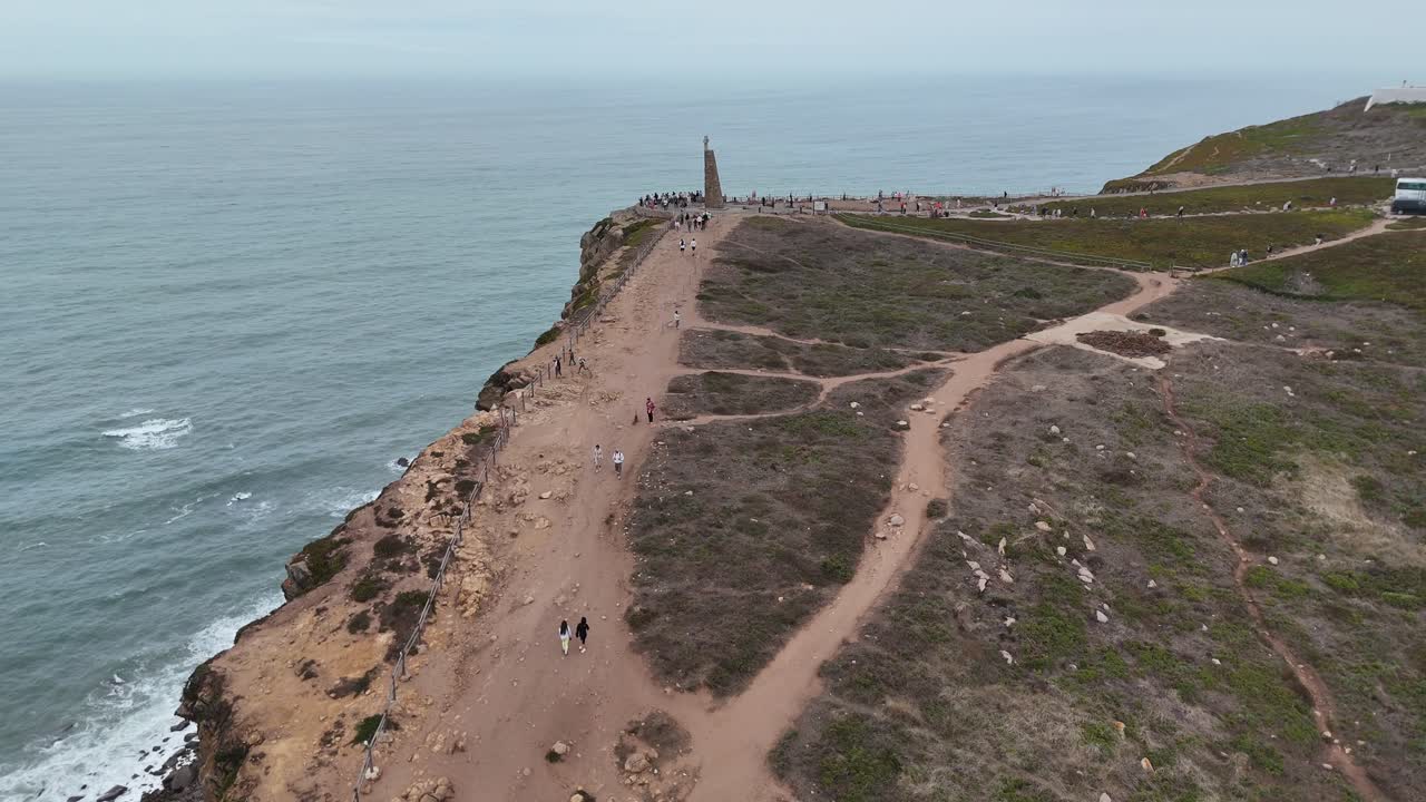 Coastal Cliff with Monument and People