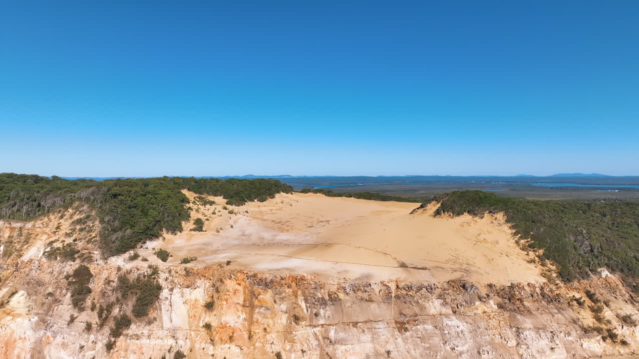 Aerial from sea over Carlo Sand Blow reveals vast Queensland lush hinterland QLD