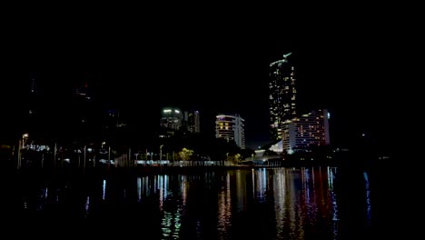 city lights reflecting on calm water at night