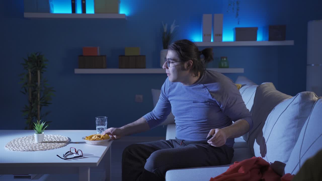Funny man dancing while listening to music from TV.