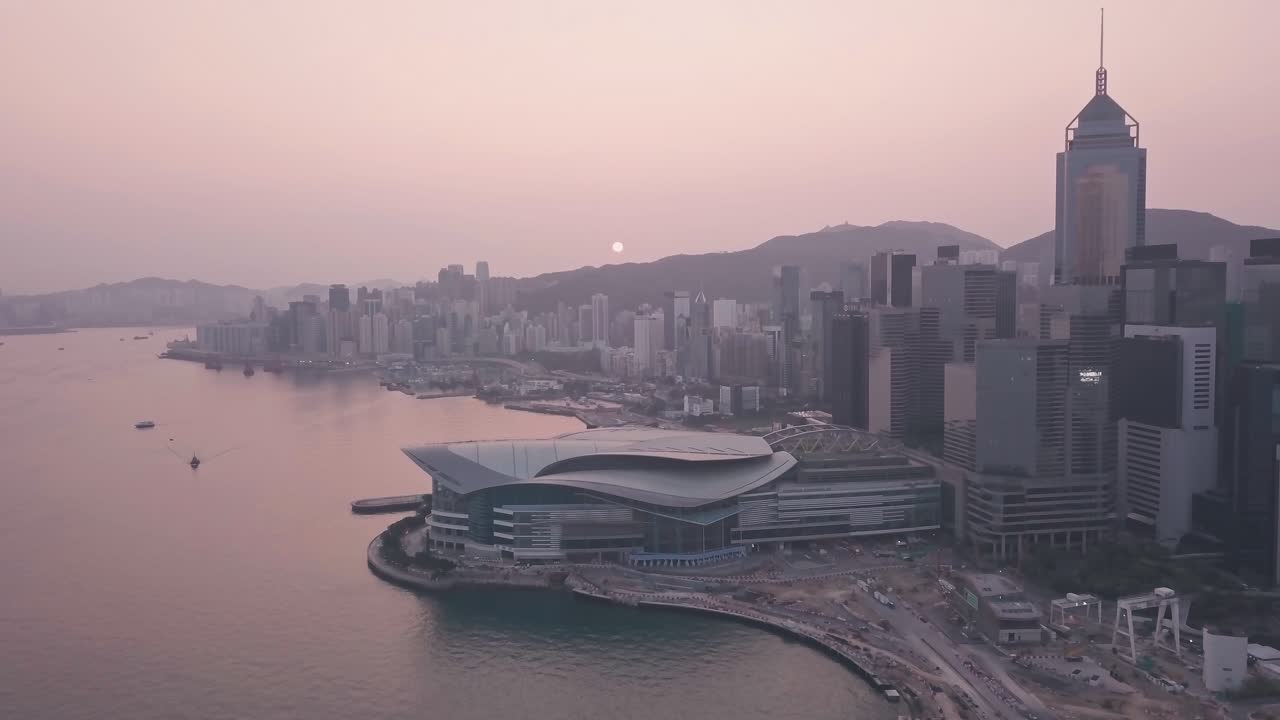 Hong Kong harbour and downtown city centre sunrise. Aerial drone view at sunrise
