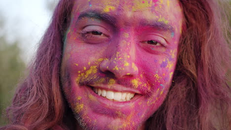 man celebrating holi with colorful powder