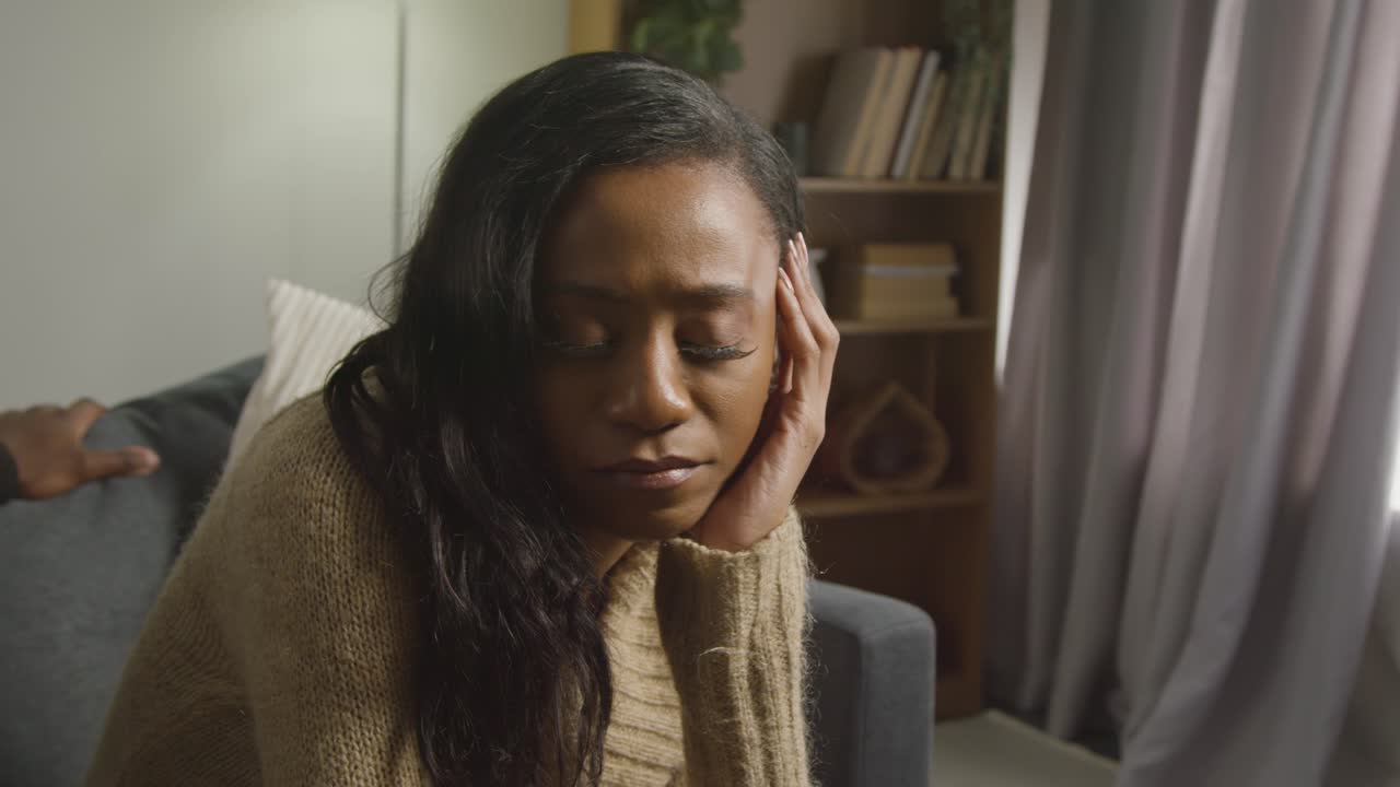 Couple At Home Sitting On Sofa In Lounge Having Argument 3