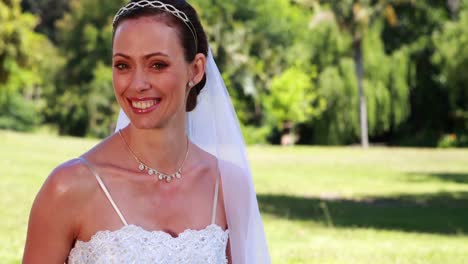 Smiling-bride-sitting-on-the-grass