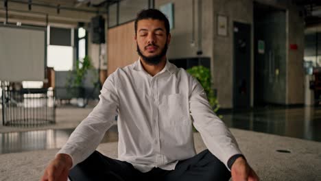 man meditating in office