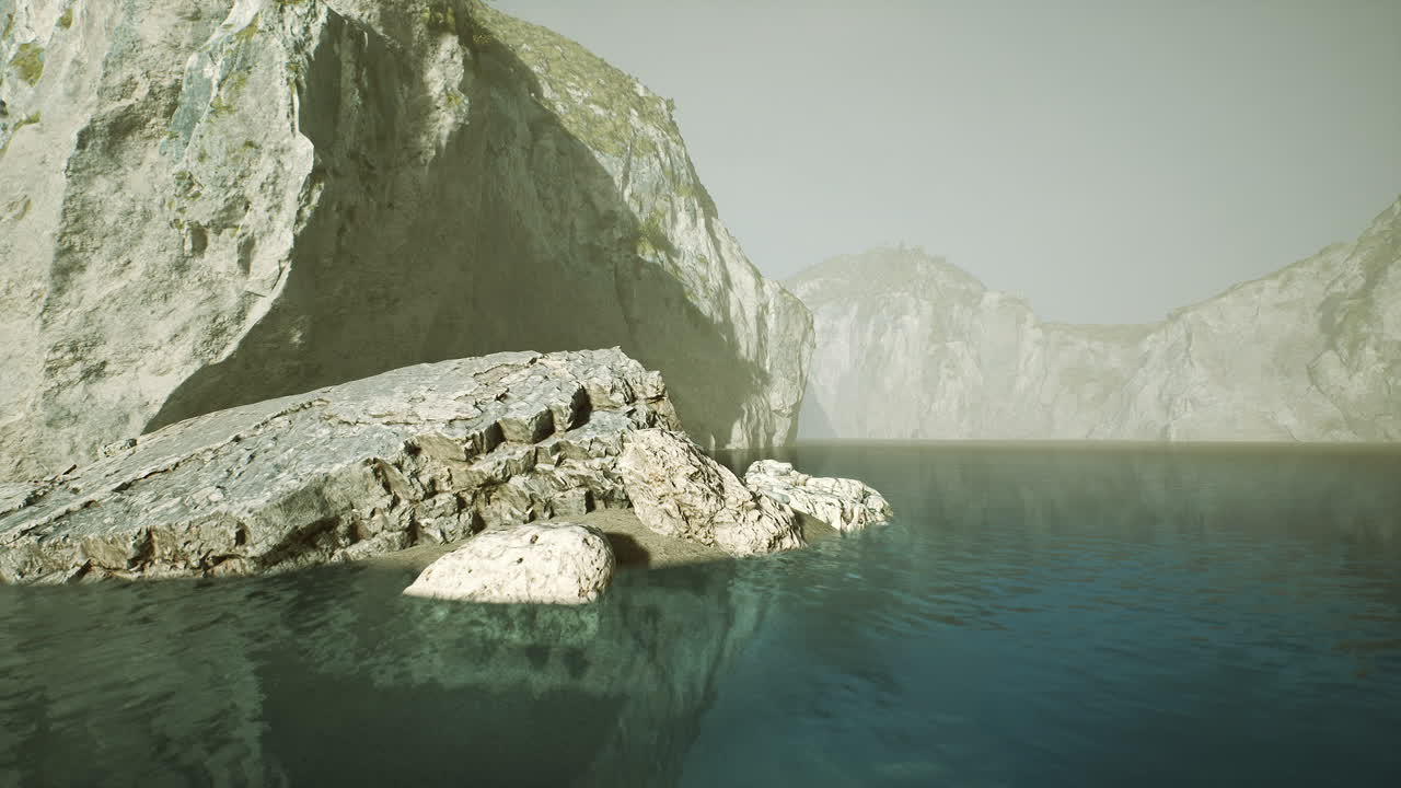 Rocky coastline with calm waters reflecting cliffs in spain at midday