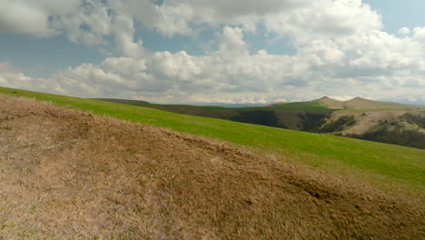 mountainous landscape with rolling hills and lush green meadows