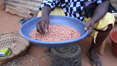 anonymous woman roasting coffee beans in village