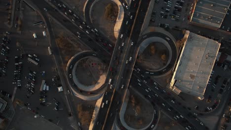 top-down slow motion view of traffic flowing through cloverleaf interchange in cuernavaca