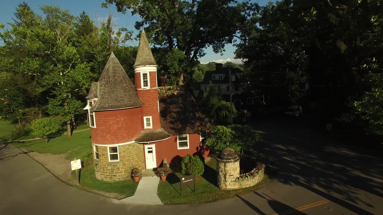 Exterior view of a unique building with trees and a road
