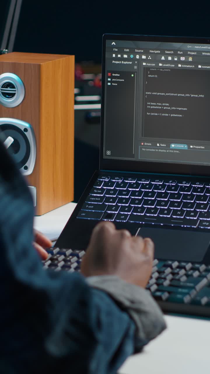 Vertical video Software developer writes code on laptop screen while in apartment office