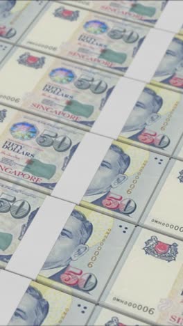 vertical video of 50 singapore dollar banknotes printed by a money press