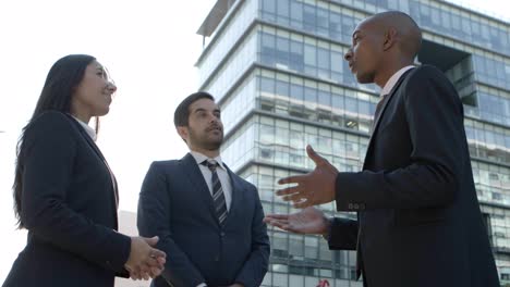 business colleagues meeting and talking on street