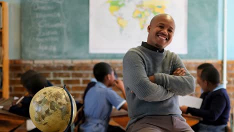 male teacher relaxing in classroom at school 4k