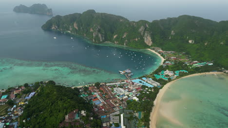 tropical rainstorm flowing over koh township and phi phi islands, aerial view