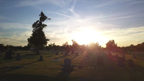 slow aerial flight across a graveyard during sunset