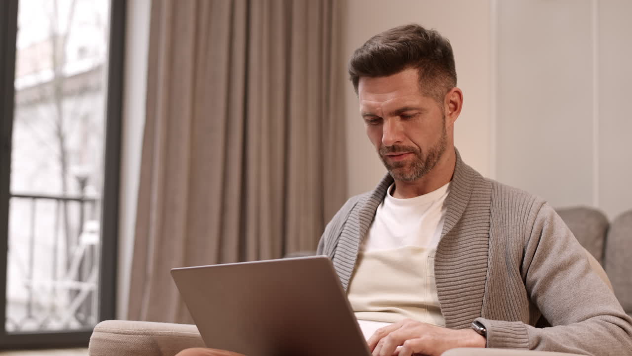 Man Writing Email on Laptop Computer