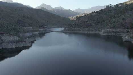 Presa-De-Sorrueda,-Gran-Canaria:-Vista-Aérea,-Cerca-Del-Agua,-De-La-Famosa-Presa-Y-Con-El-Agua-Completamente-Tranquila