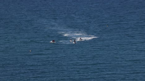 Hand-held-shot-of-a-jet-ski-tour-regrouping-off-the-Newquay-coast,-Cornwall