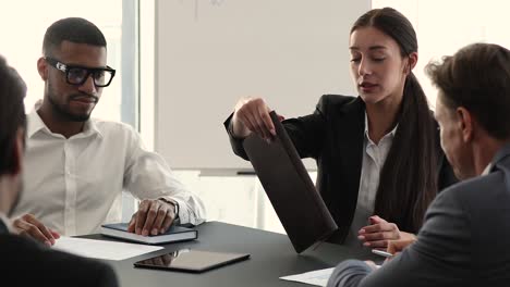 diverse group of company employees gather in boardroom for briefing