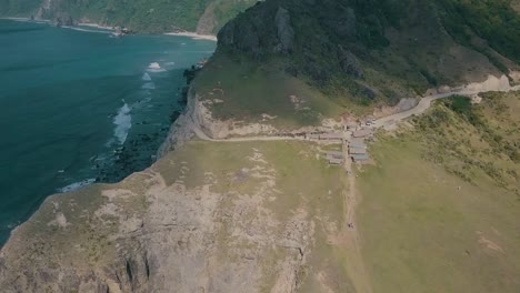 video cinematográfico de drones aéreos de salpicaduras de olas oceánicas en una pintoresca montaña de sabtang, batanes en filipinas