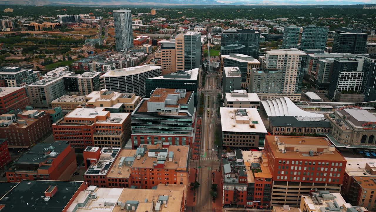 Diverse high-rise buildings in the cityscape of Denver, Colorado, USA. Lots of greenery in the city scenery at backdrop