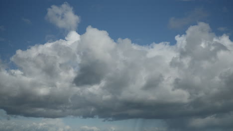 cumulonimbus clouds moving left to right with light rain band underneath