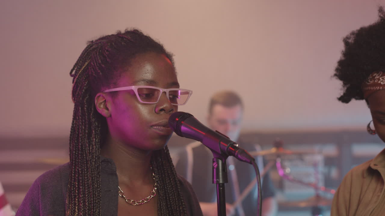 Multiethnic Music Band Rehearsing In Recording Studio 7