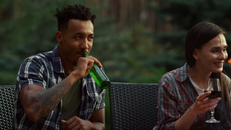 African-american-man-laughing-on-bbq-party.-Couple-having-rest-on-backyard