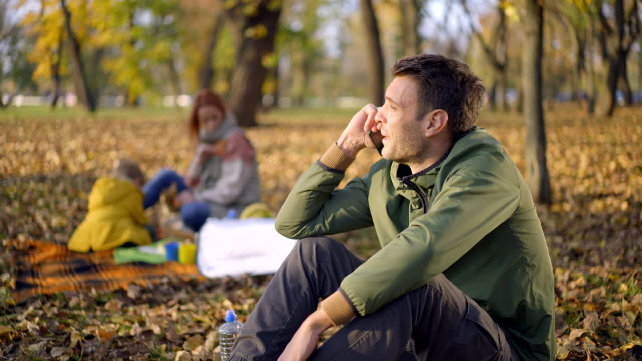 Family picnic in the autumn park