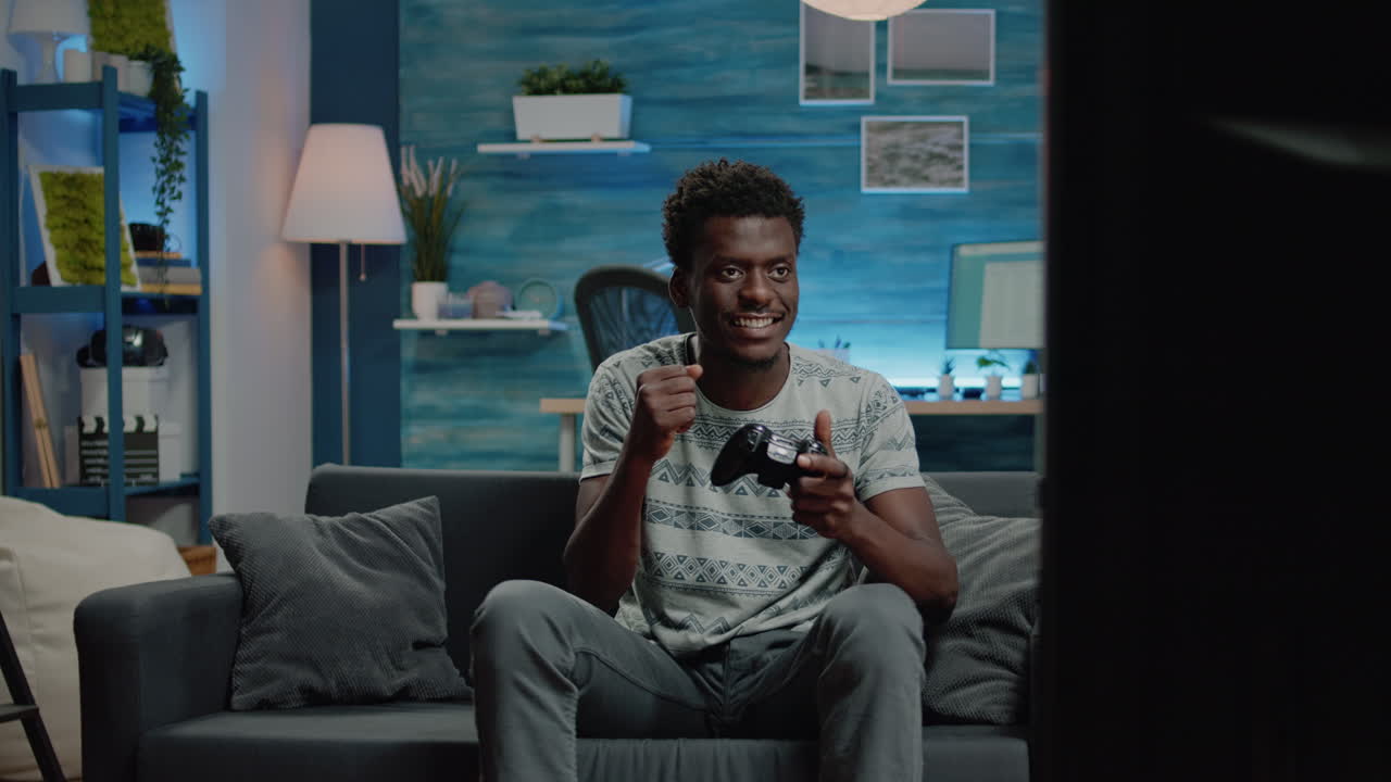 Person smiling after winning video games on television