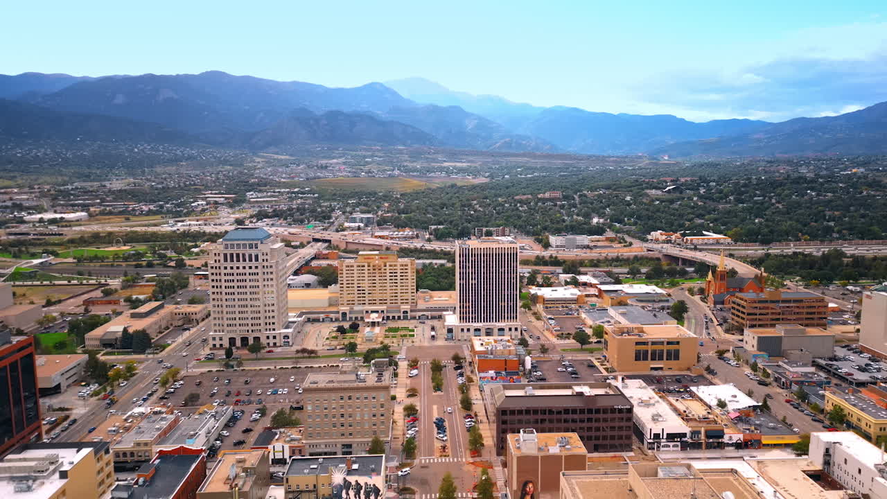 Colorado Springs, USA, 22 July 2025: Vast cityscape of Colorado Springs, Colorado, USA. Downtown and green uptown with mountains at backdrop. Aerial view