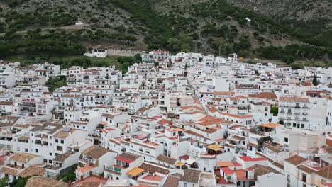 slow reveal of traditional spanish buildings behind a bullring in mijas, spain