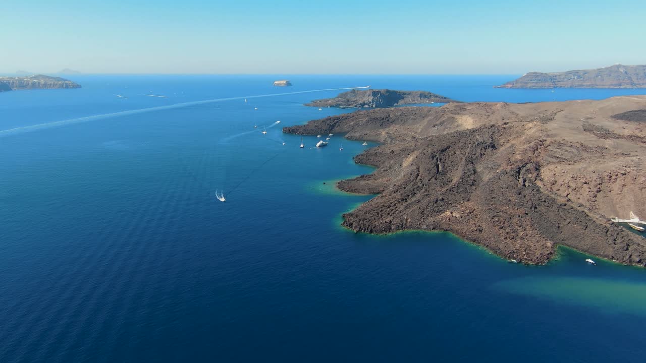 4K cinematic drone footage of Nea Kameni, Greece, showcasing the volcanic island, rugged lava terrain, and steaming fumaroles surrounded by the deep blue Aegean Sea.02