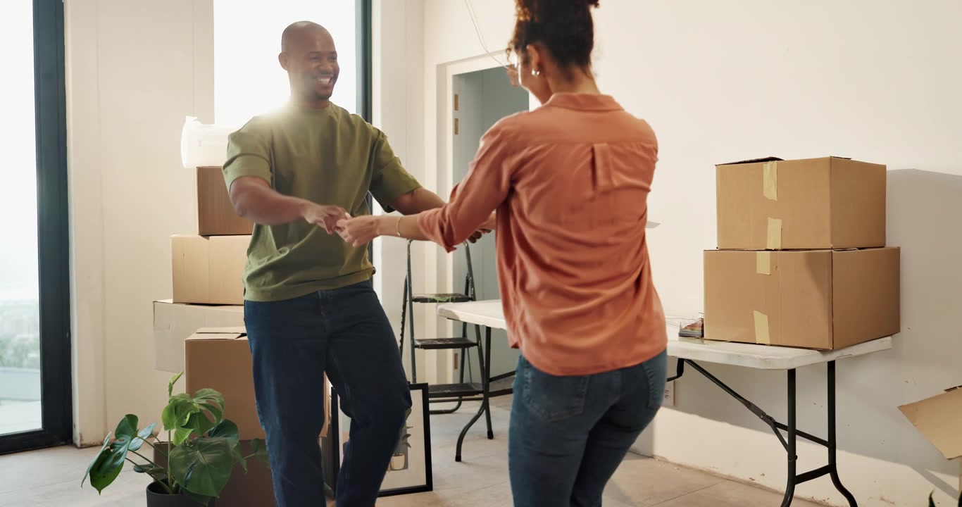 Happy Couple Dancing Together in Their New Home