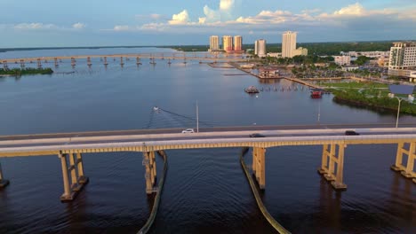 cars driving on bridge to fort myers, florida, aerial sideways, river panorama