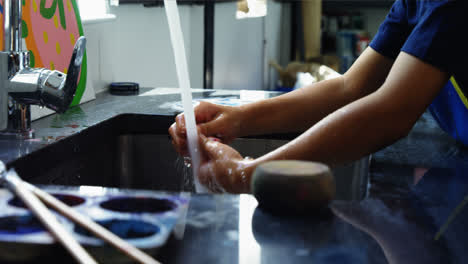 Schoolboy-washing-his-hand-after-drawing-class